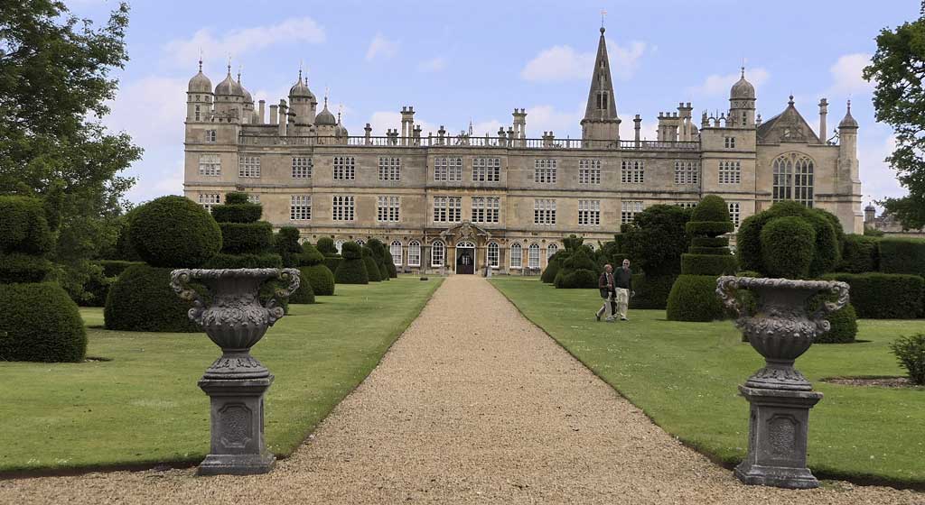 Burghley house and the path in the garden leading to the large estate