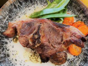 Restaurant food, peas and carrots with roast meat