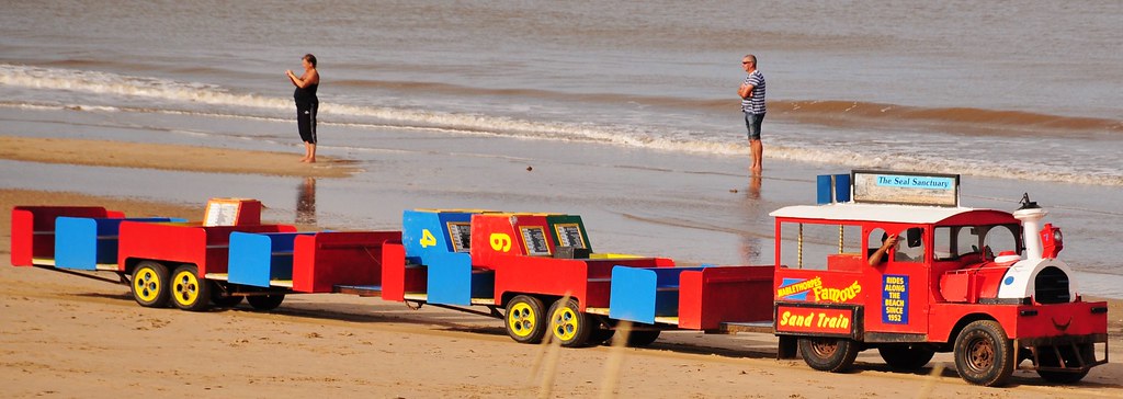 Mablethorpes sand train on the sea side. A red and blue train