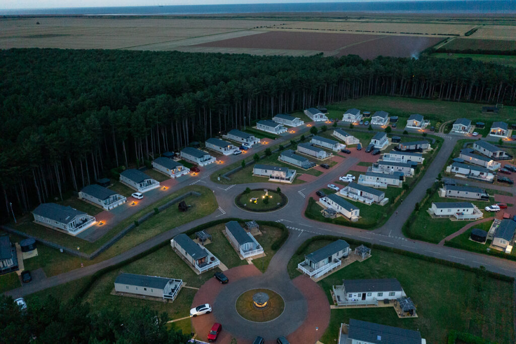 Lakeside park field from an aerial view at dusk
